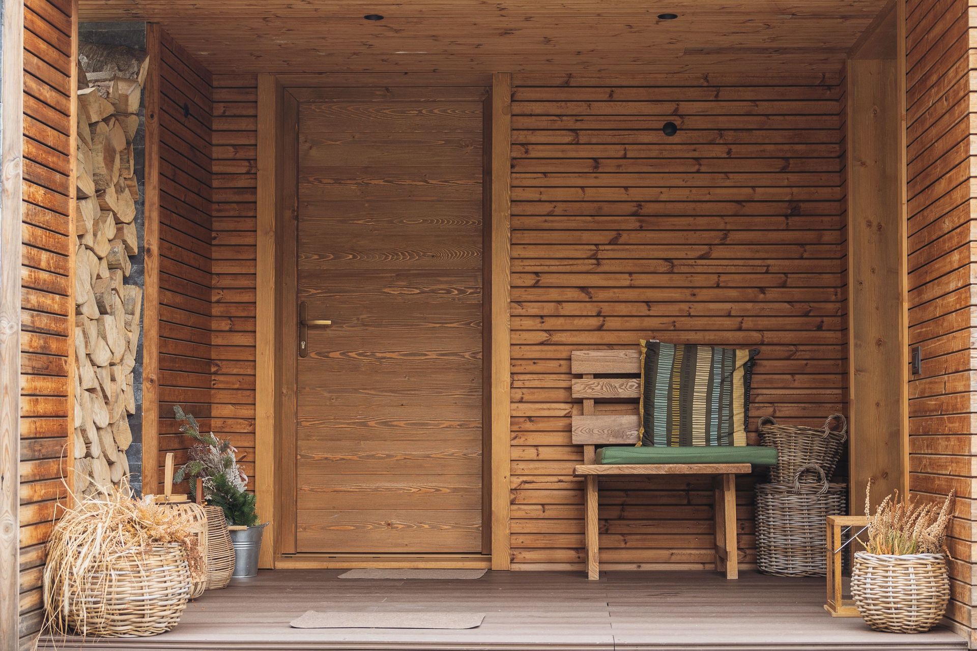 Inviting wooden porch featuring rustic decor and a comfortable seating area.